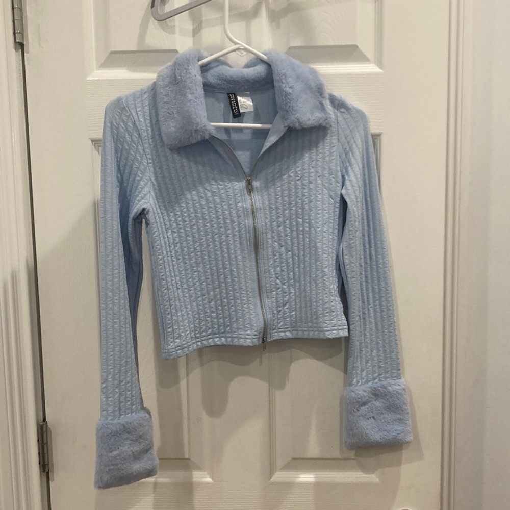 Blue zip up sweater with faux fur around the neck and wrists